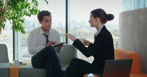 Colleagues Communicate In A Relaxed Atmosphere During A Break At Work Stock Footage 129134819