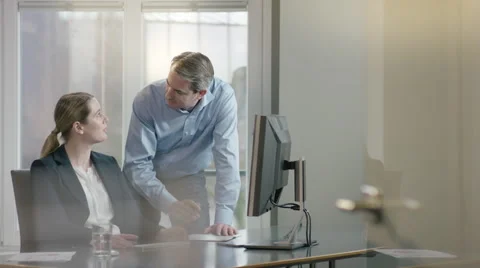 Colleagues comparing notes, discussing work Stock Footage 66914363