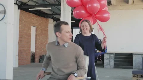 Colleagues congratulate the young manager. They ride him in an office chair Stock Footage 134165008