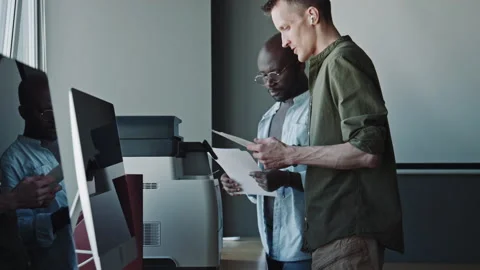 Colleagues Copying Documents with Printer in Office Video stock 275071448
