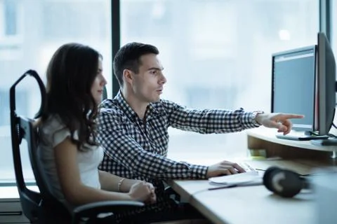 Colleagues developing software together in office Fotos Stock