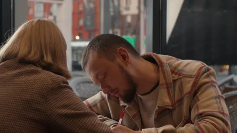 Colleagues discuss a future work project during an informal meeting Stock Footage 323168811