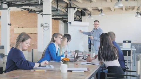 Colleagues discuss the presentation while sitting at the table. Businessman - Stock Footage 111647124