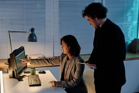 Colleagues discussing codes of computer program Foto stock