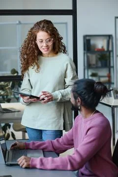 Colleagues discussing computer project together Stock Photos