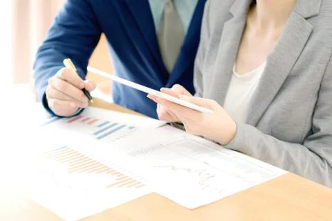 Colleagues discussing data on touchpad Stock Photos