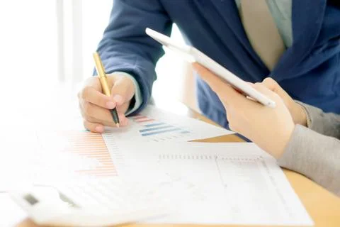 Colleagues discussing data on touchpad Stock Photos