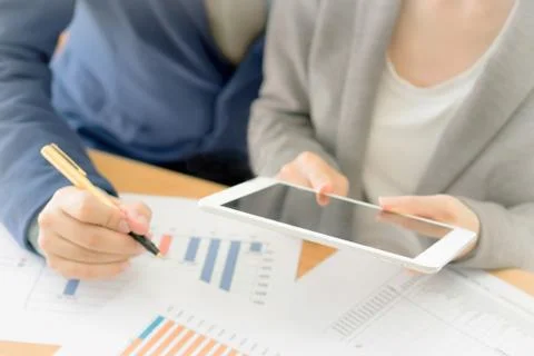 Colleagues discussing data on touchpad Stock Photos