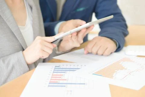 Colleagues discussing data on touchpad Stock Photos