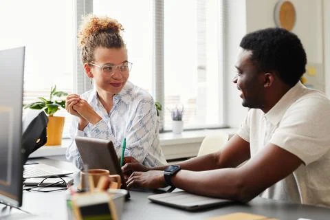 Colleagues discussing new computer program Stock Photos