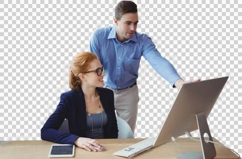 Colleagues discussing over computer at table Stock Photos