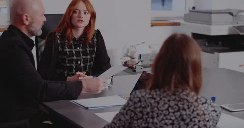 Colleagues discussing over documents in board room Stock Footage 171578537