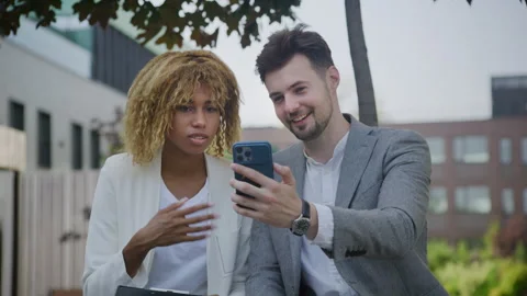Colleagues Discussing Project on Video Call Outdoors Stock Footage 265964436