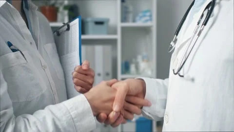 Colleagues doctors stand together talking. The head doctor explains the pati Stock Footage 170781676
