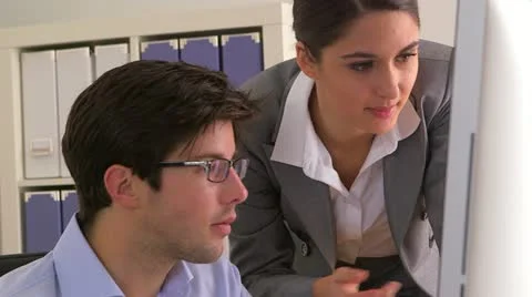 Colleagues doing work on a computer Video stock 21377222