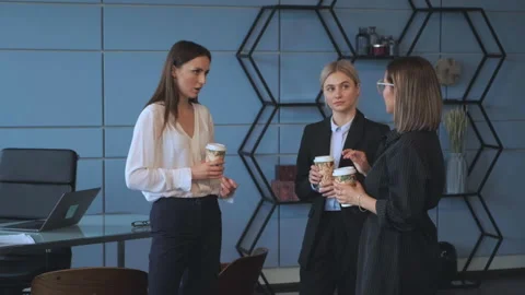 Colleagues drink coffee and chat about new projects during a break Stock Footage 131845643
