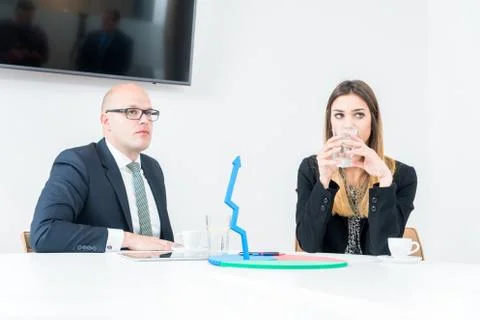 Colleagues drinking coffee in office while discussing new project Stock Photos
