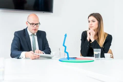 Colleagues drinking coffee in office while discussing new project Stock Photos