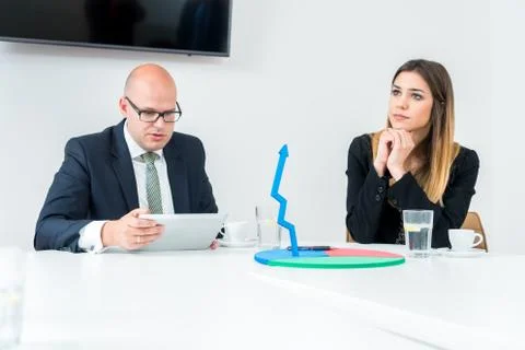 Colleagues drinking coffee in office while discussing new project Stock Photos