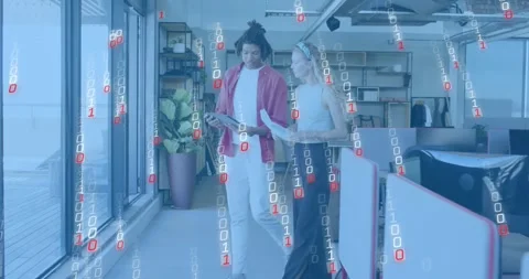 Colleagues entering office holding sheets and comparing tech data on tablet with Stock Footage 317258703
