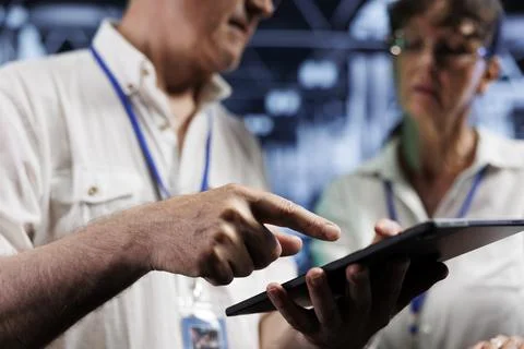Colleagues examine supercomputers 写真素材