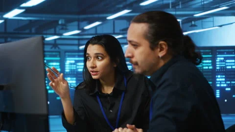 Colleagues examining infrastructure in data center Stock Footage 276194339