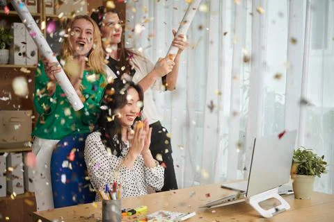 Colleagues Exploding Party Poppers Stockfoto's