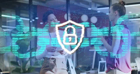 Colleagues gesturing in tech office causing code swirl around shield icon Stock Footage 315538196