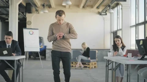 Colleagues have fun in office, talk and ride in an office chair. Stock Footage 165385606