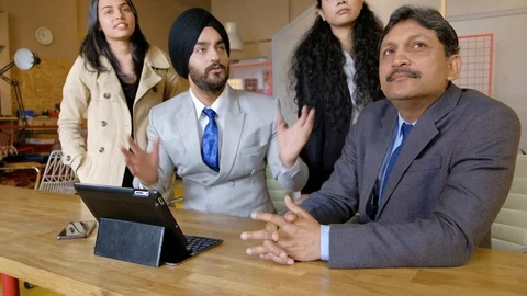 Colleagues having  a work discussion with someone off camera as they are learnin Stock Footage 101890838