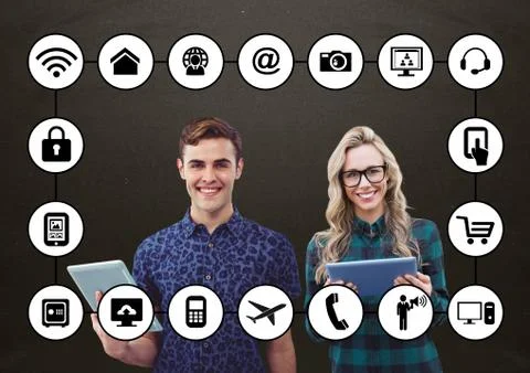 Colleagues holding digital tablet with application icons on grey background Stock Photos