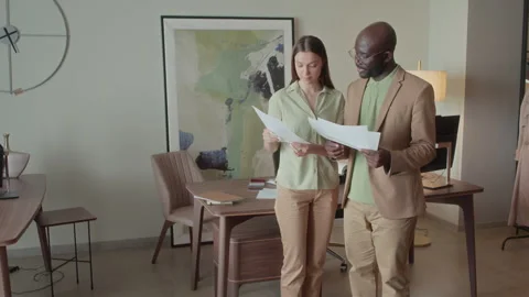 Colleagues Holding Documents with Various Interior Designs Stock Footage 256912176