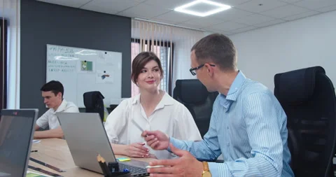 Colleagues jointly solve a problem in the office Stock Footage 159529546