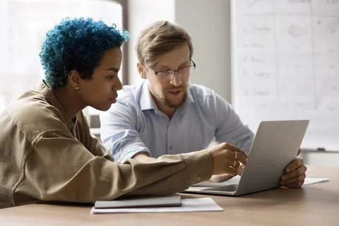 Colleagues learning new corporate program working together using laptop Foto stock