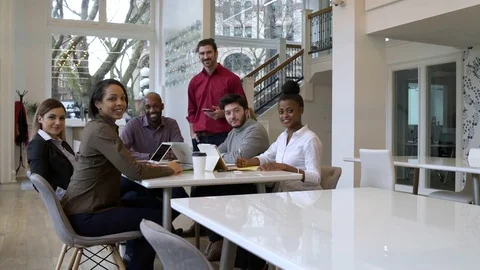 Colleagues looking at camera in an office 動画素材 77080825