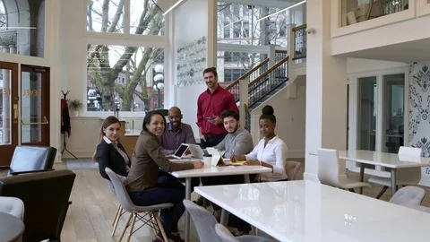 Colleagues looking at camera in an office 動画素材 77080830