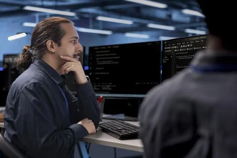 Colleagues looking for data center bugs causing infrastructure to slow down Stock Photos