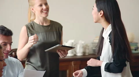 Colleagues looking at digital tablet during casual meeting Stock Footage 63293341