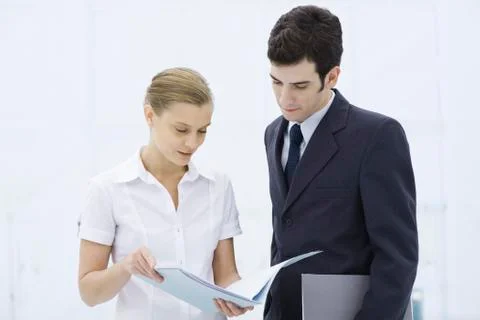 Colleagues looking at document together Stock Photos