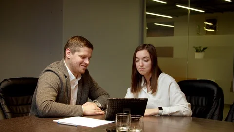 Colleagues looking at tablet together Stock Footage 127176369