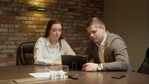 Colleagues looking at tablet together Stock Footage 127176742