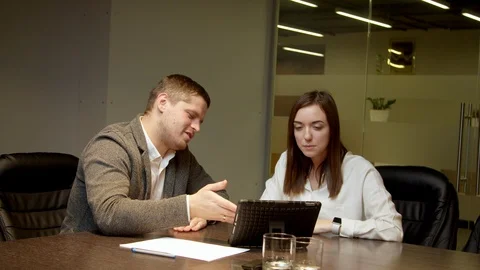 Colleagues looking at tablet together Stock Footage 127180764