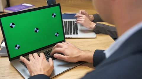 Colleagues in the office work on laptops. A man and a woman type on a keyboard. Stock Footage 231893420