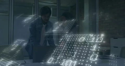 Colleagues opening laptop and analyzing business data while holo binary grid Stock Footage 330713652