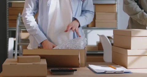 Colleagues Packing Parcels In Cardboard Boxes For Delivery 库存影片 286204778