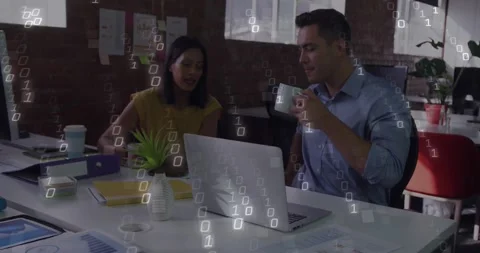 Colleagues pointing at laptop screen in loft causing binary code animating data Stock Footage 330772075