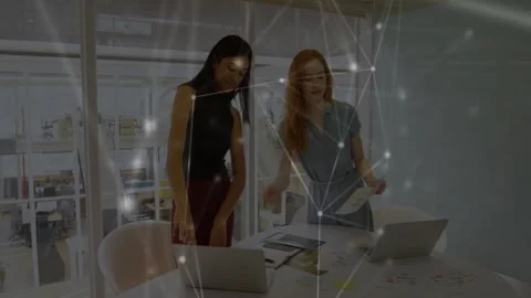 Colleagues positioning laptop and sharing document comparing animated chart data Stock Footage 309723030