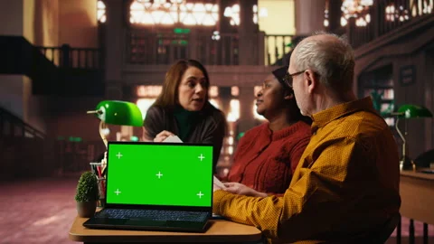 Colleagues practicing script reading in a public library with mockup Stock Footage 313310821