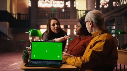 Colleagues practicing script reading in a public library with mockup Stock Photos