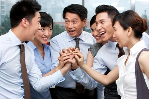 Colleagues Putting Their Hands In Stock Photos
